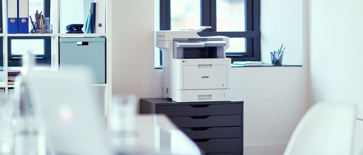 Brother printer powered by managed print services on a chest of drawers in a small office environment