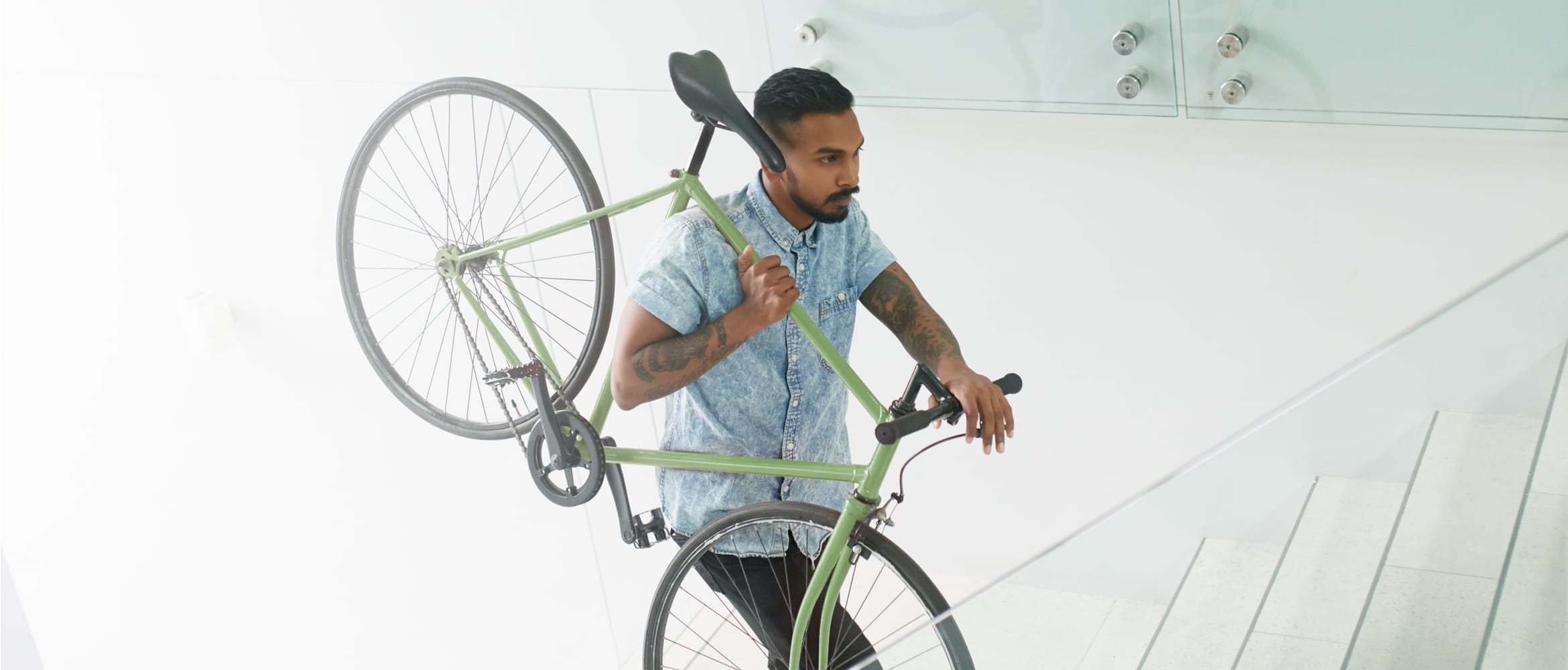 Man carrying a bike up the stairs