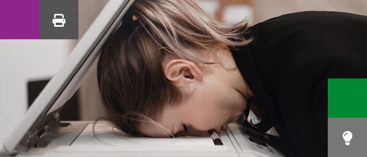 A business woman with her head face down in a photocopier