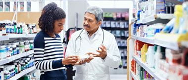 Pharmacist and a customer chatting about a product