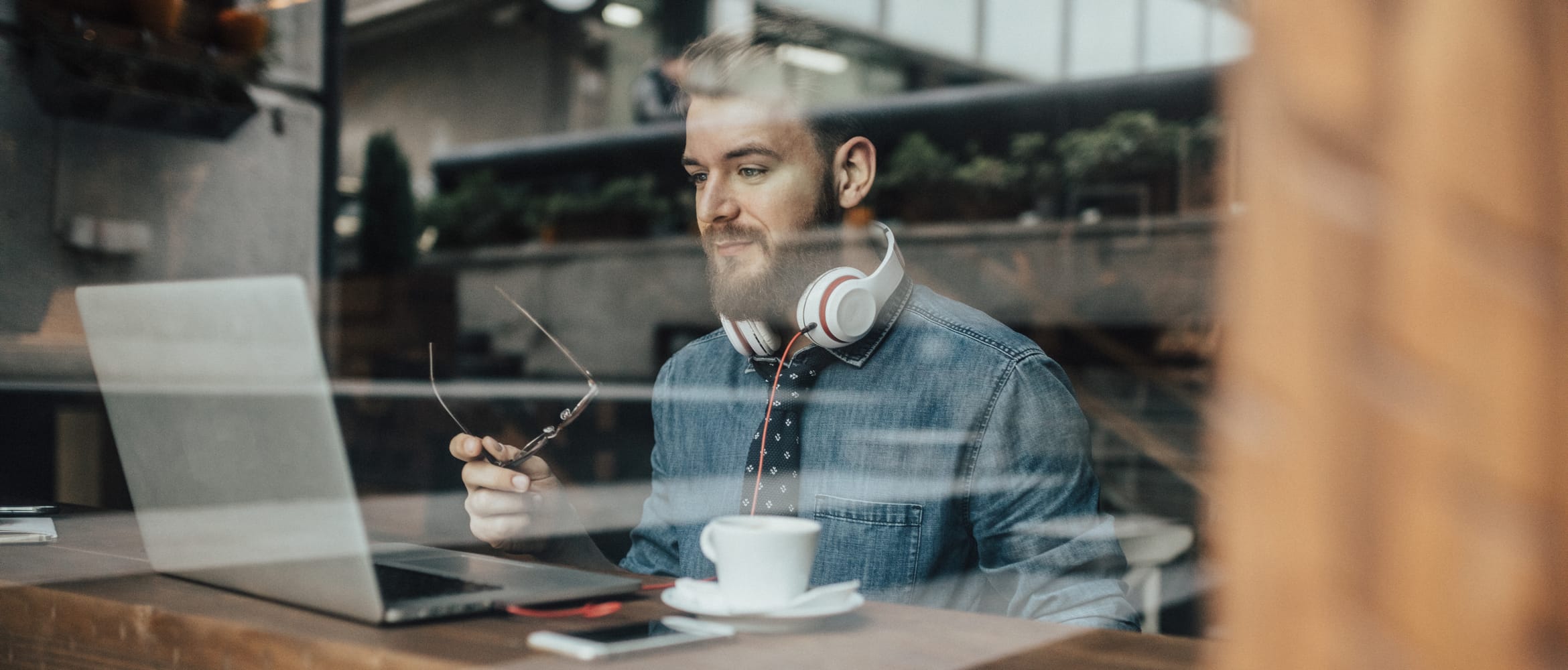 millennial remote working in a coffee shop