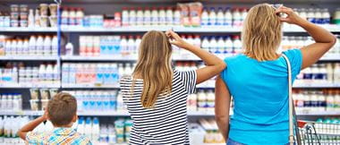A family scratch their heads looking at a supermarket shelf to illustrate retail customer pain points