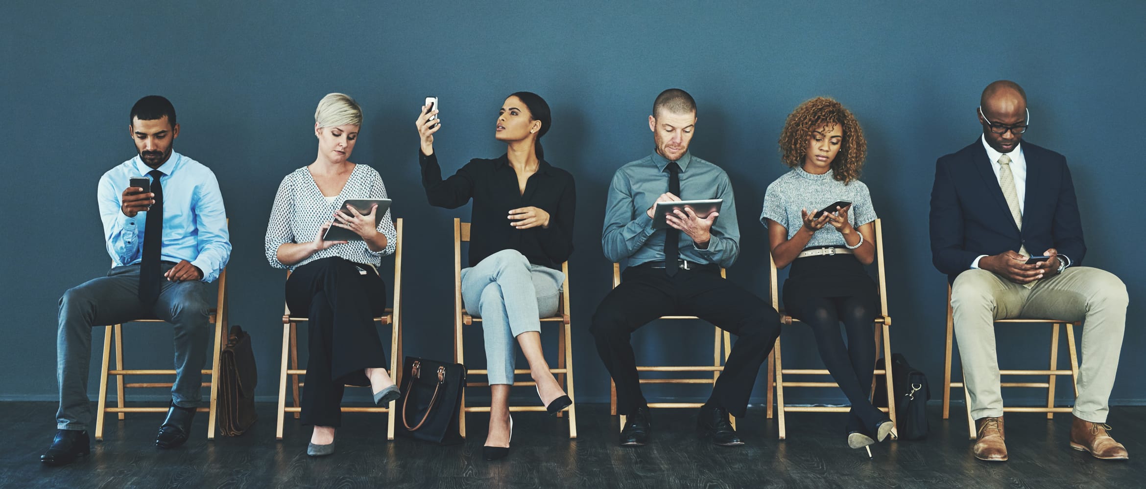 a queue of people sitting in a business' waiting room