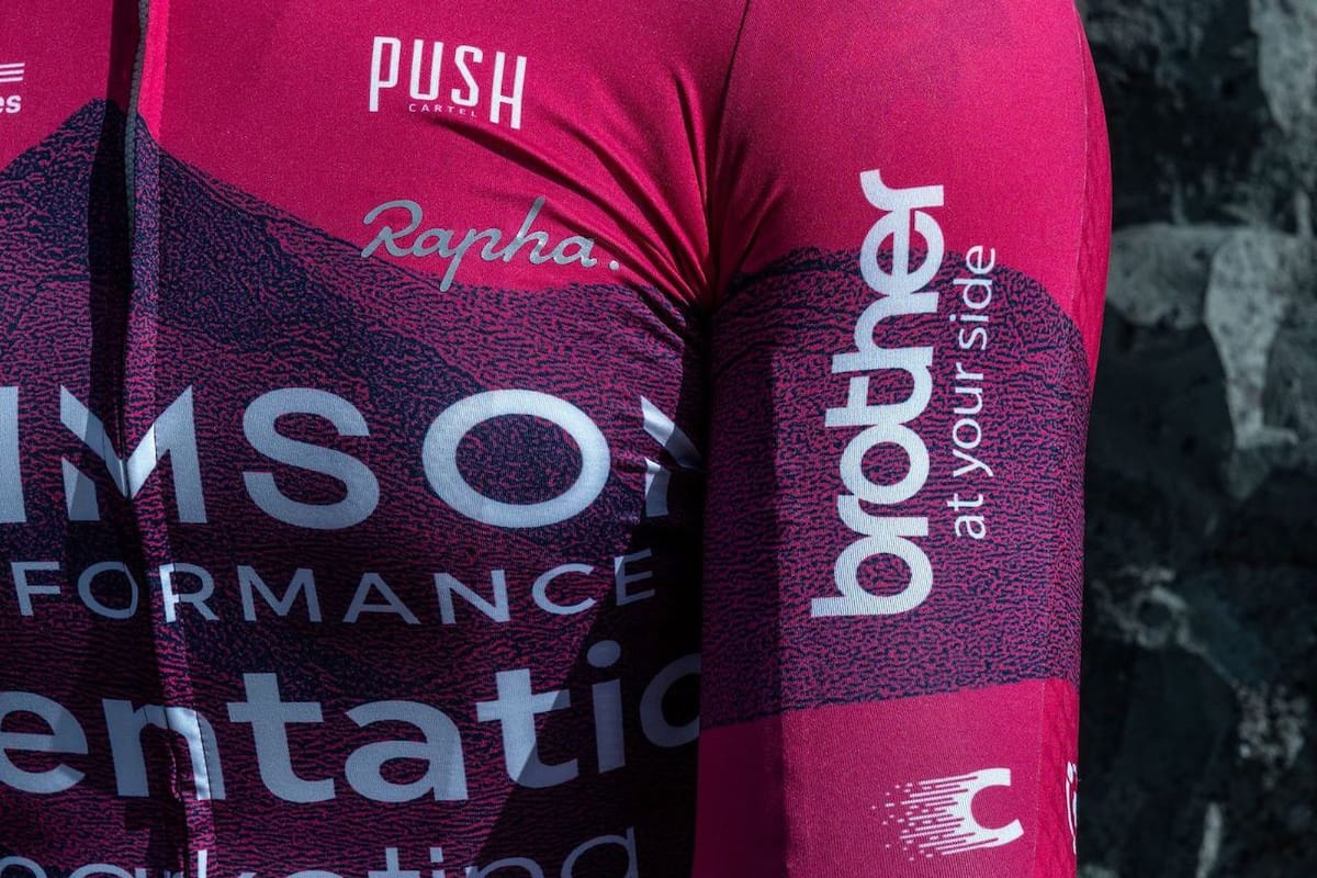 Close-up of Crimson Performance team jersey displaying sponsorship logos