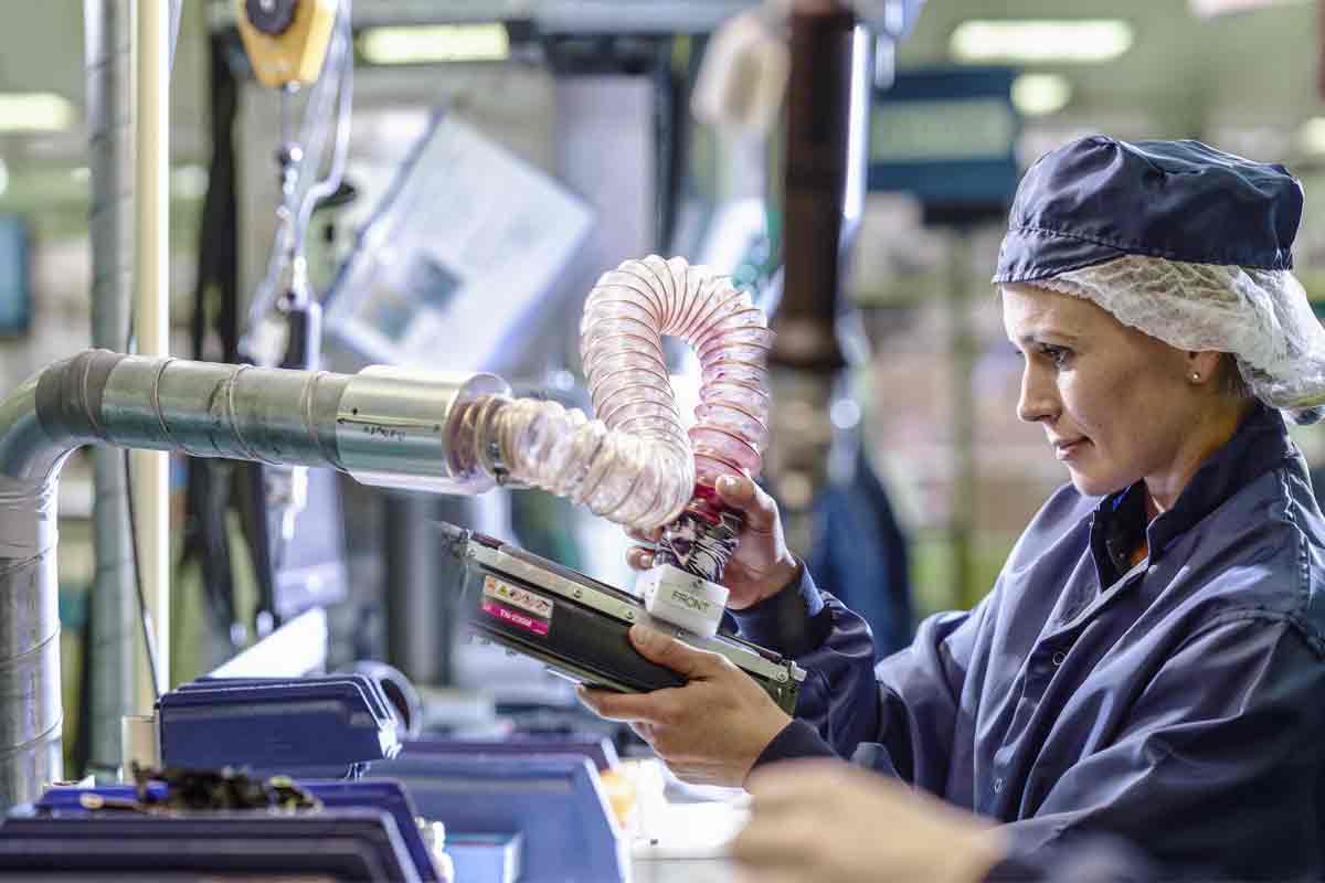 A lady in a recycling facility testing a cartridge