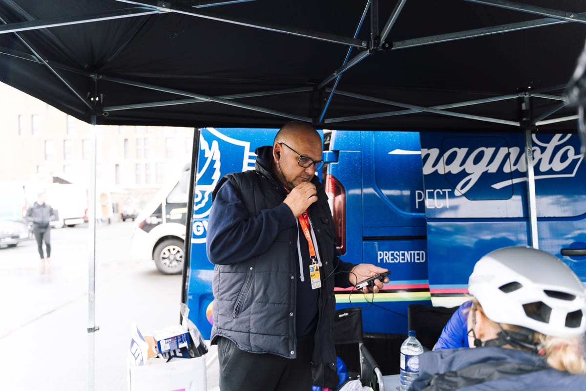Brother UK-Tifosi p/b OnForm team member talking handsfree on his phone in front of a support vehicle