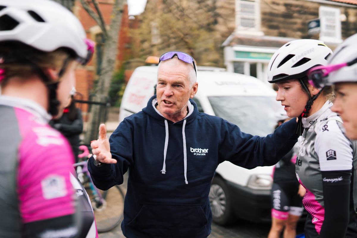 Brother UK-Tifosi p/b OnForm team member gesturing while talking to three cyclists