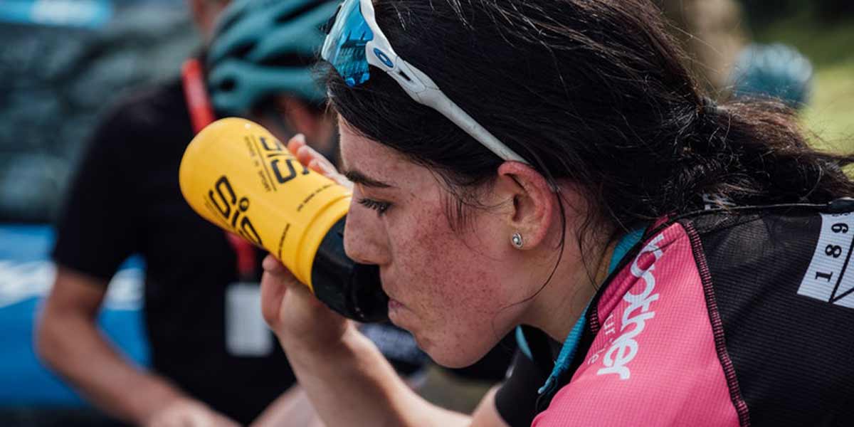 Anna Henderson, pro cyclist, drinking from a water bottle