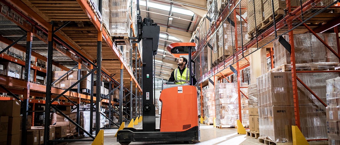 Man working in a warehouse on a picking machine