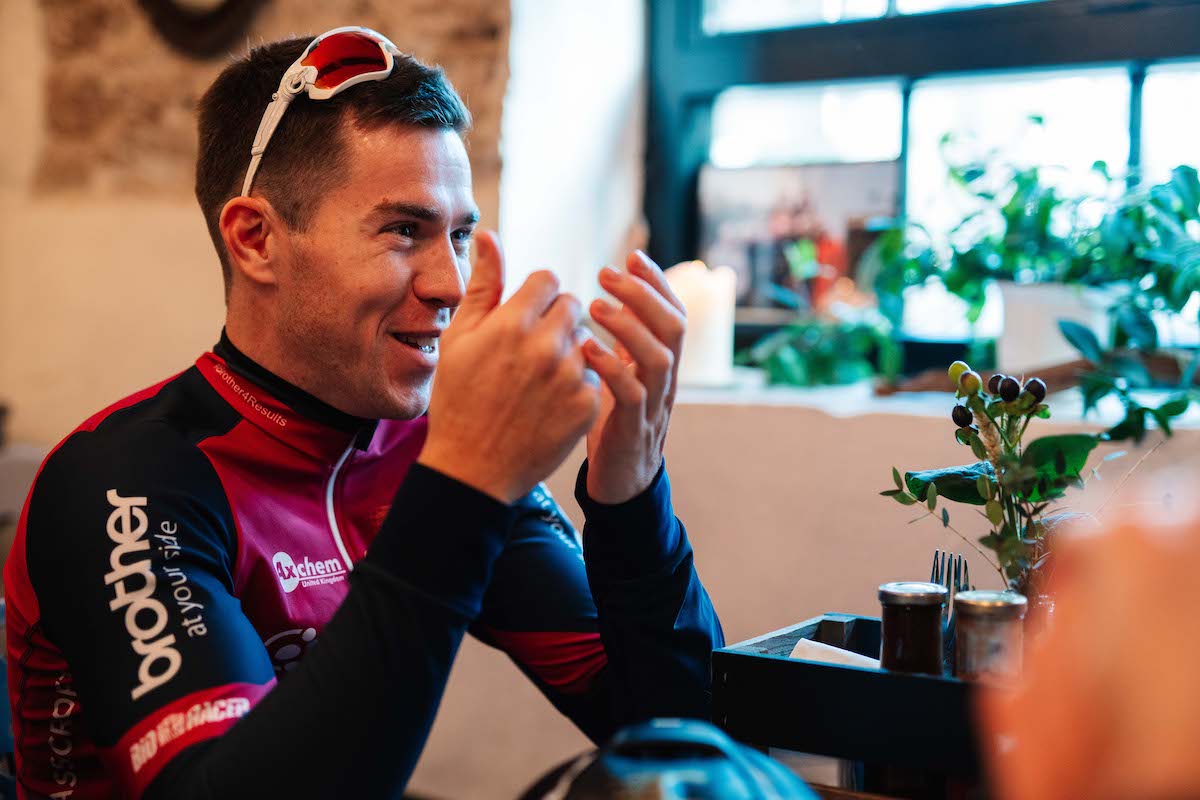 Alistair Thomas from Crimson Performance cycling team with his hands in the air