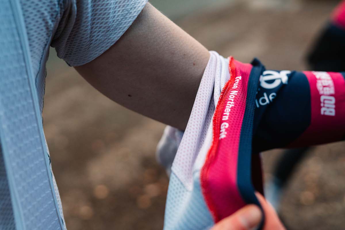 cyclist putting on a cycling jersey