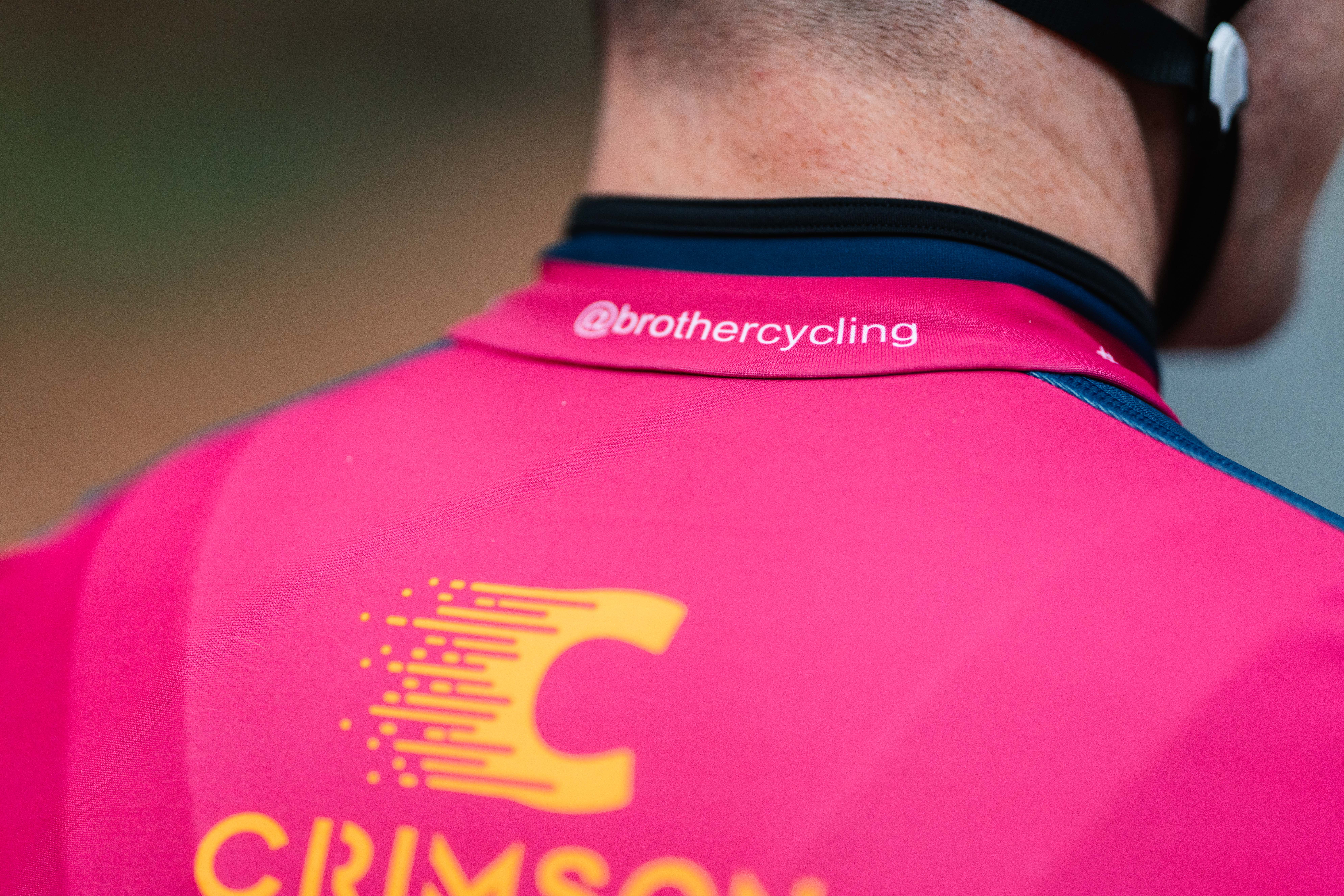 Close up of the @brothercycling handle on a Crimson Performance cycling team jersey