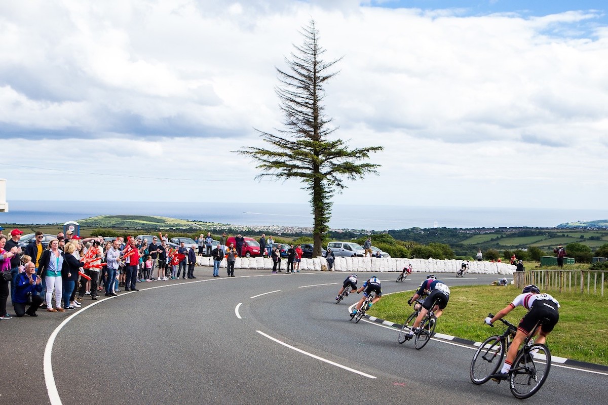 cyclists negotiate a corner in road race