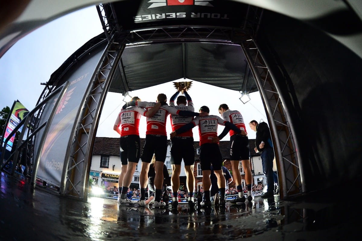 view from behind the podium as a team lift the trophy for the tour series win