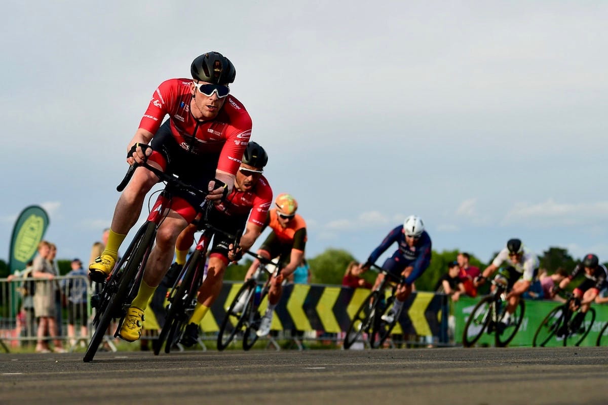 Ed Clancy leading a group of other cyclist as they turn a corner