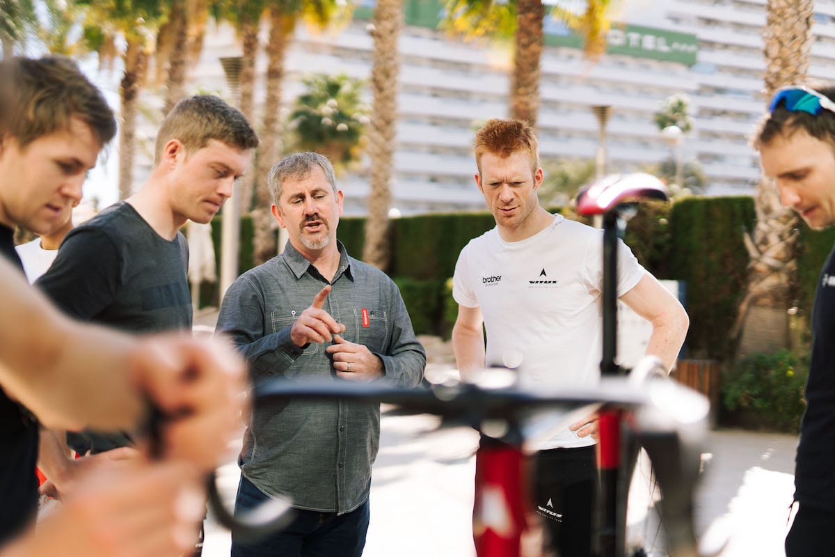 Cyclist Ed Clancy at a team briefing in a hotel carpark