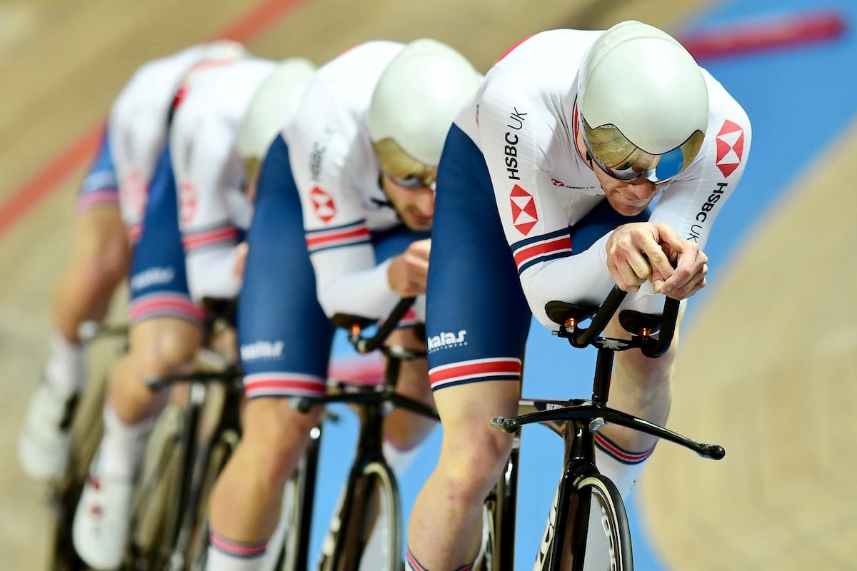 Ed Clancy with four team mates cycling at a velodrome