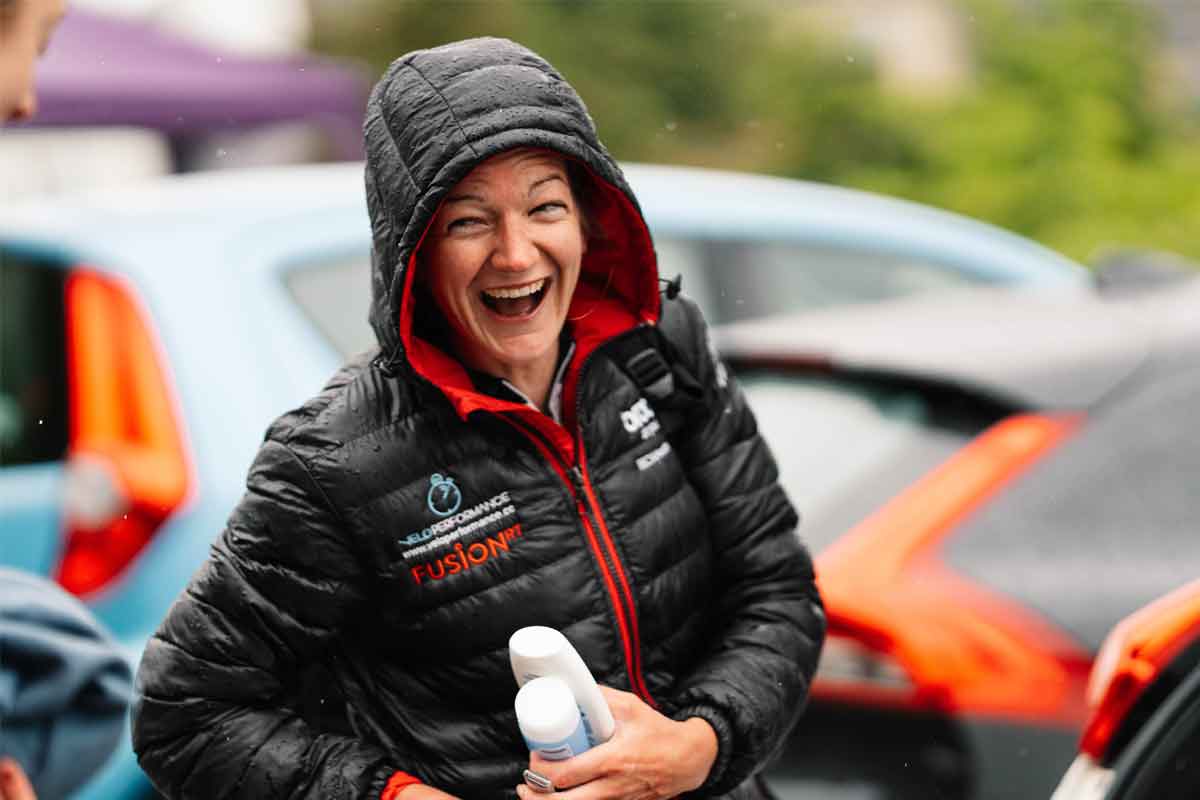 Fusion RT cyclist in the rain, laughing with hood up
