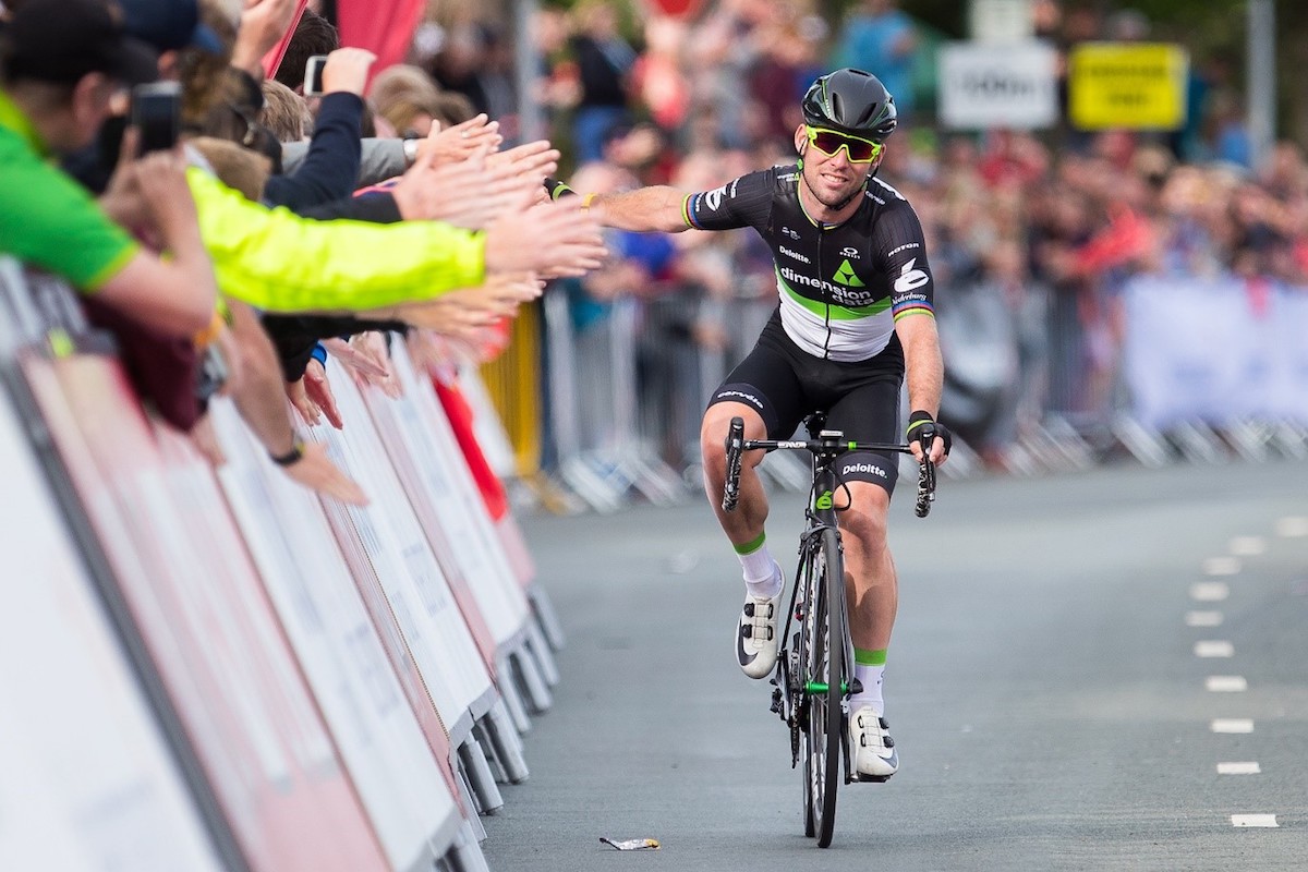 cyclist gives high fives to fans along the race perimeter