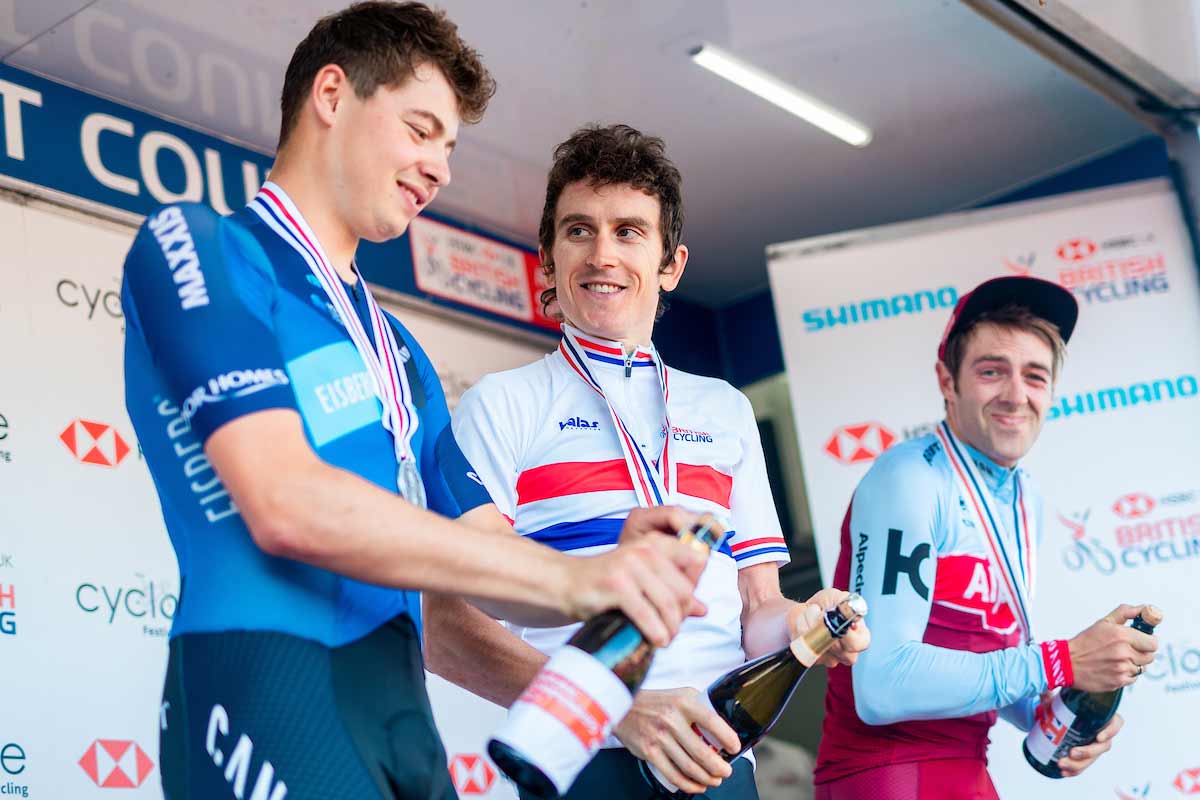 Three cyclists opening champagne
