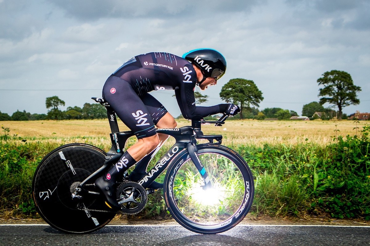 team sky cyclist at top speed with sun glinting from spokes