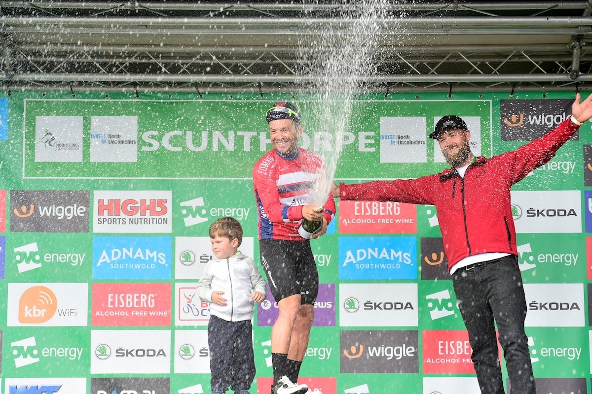 cyclist celebrates tour stage win in Scunthorpe with champagne