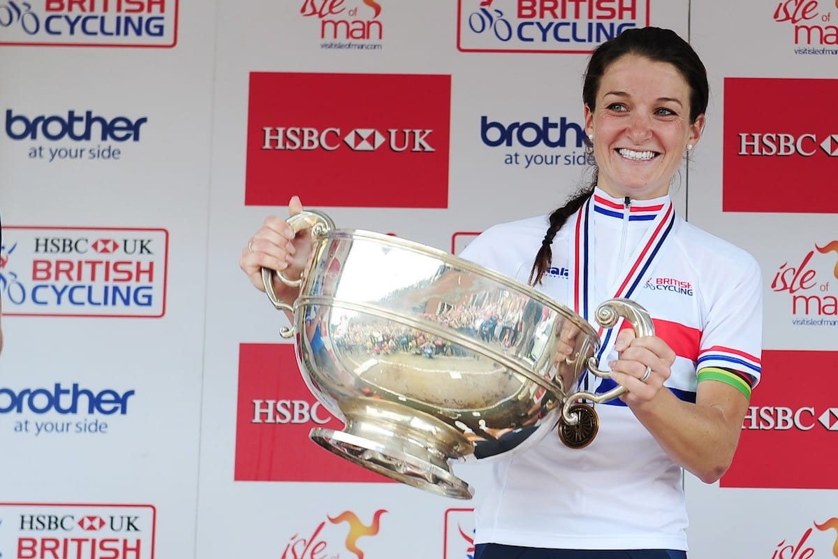 Lizzie Deignan celebrates by lifting the trophy