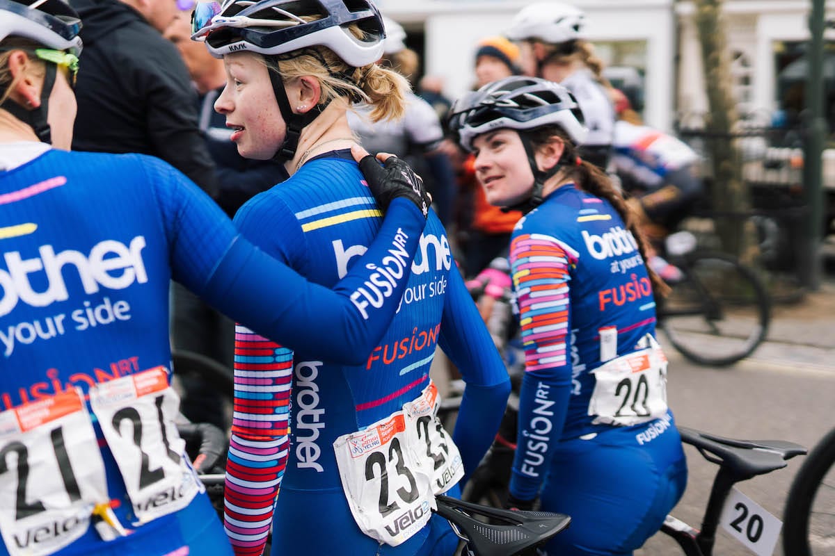 Team mate puts her arm around Molly Patch's shoulder