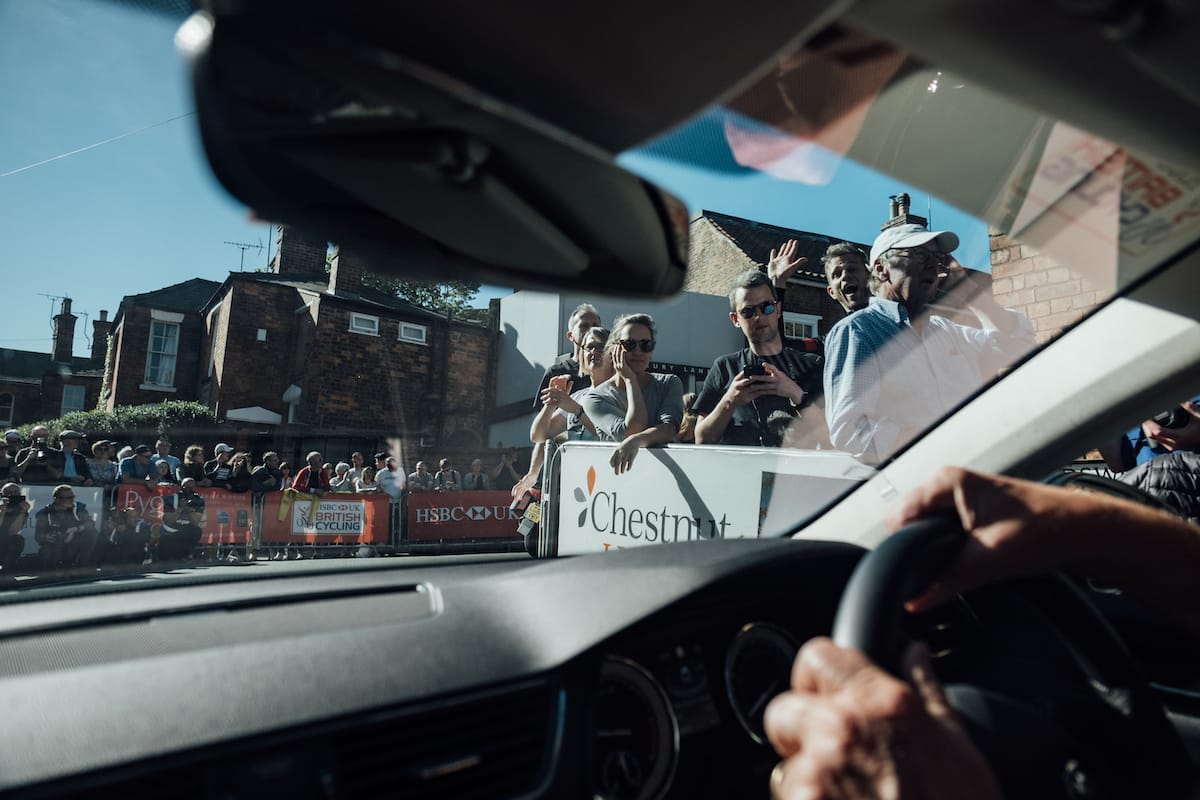 A view from the front passenger seat of a Neutral Service race support vehicle as it drives past spectators at the Lincoln Grand Prix