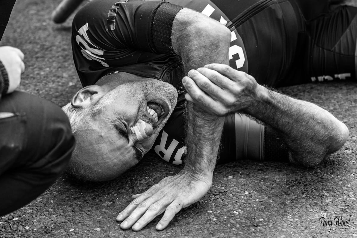 Cyclist Rich Stoodley lying on the ground in pain after a gruelling hill climb
