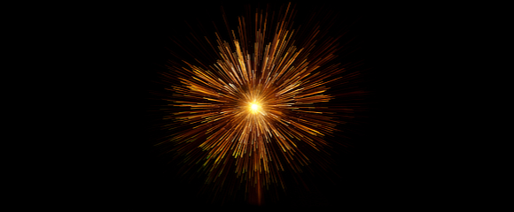 Orange firework exploding on a black background