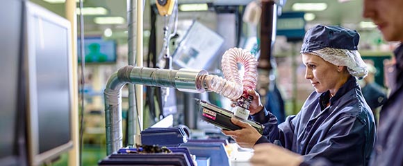 a papers sizes Brother recycling factory worker testing empty toners ready to be refurbished