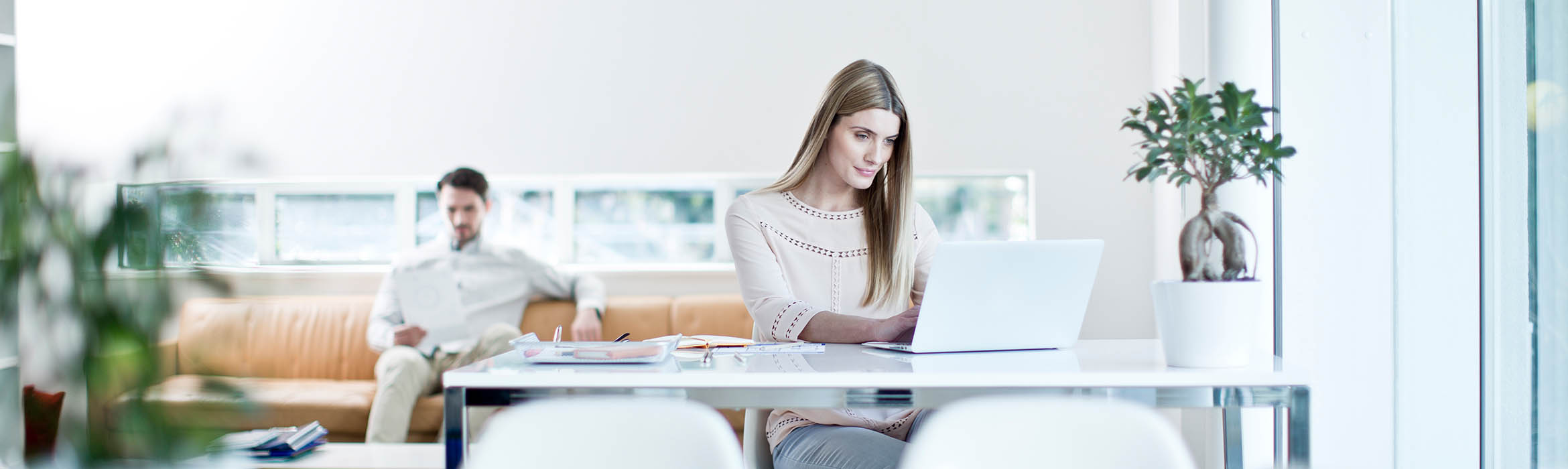 woman sat at a desk on a computer