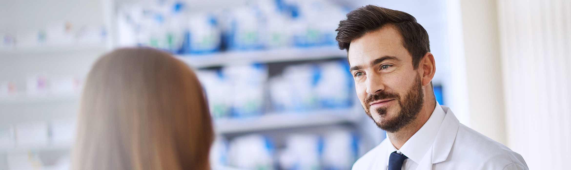 Two pharmacy colleagues chatting to each other