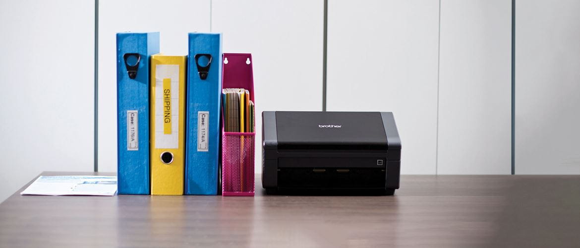 Brother PDS-5000 high-volume document scanner with A4 files on a desk