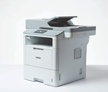 3/4 view of Brother MFC-L6900DW laser printer on white surface and background