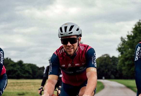 Alistair Thomas of Brother UK-supported Crimson Performance cycling along a path in Tatton Park