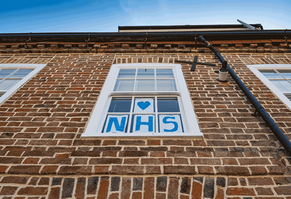 a homemade sign to show support towards the NHS in a window