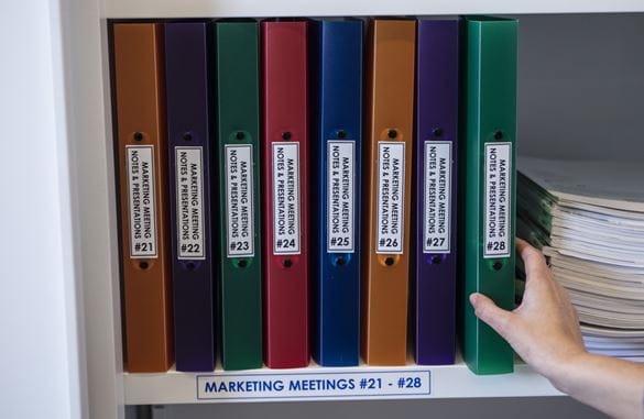 File folders in a cabinet clearly labelled using a durable Brother P-touch label