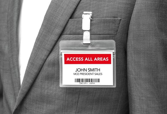 Close-up of a red and black access all areas ID card clipped to a businessman's suit jacket