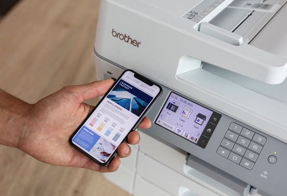 Close-up of a person printing a colour document from a smartphone to a wireless all-in-one printer