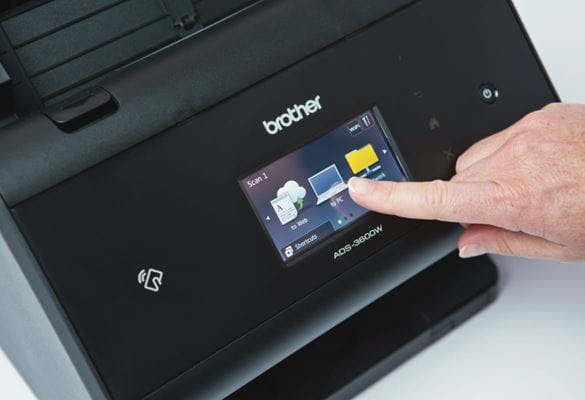 Close-up of a person selecting a secure scan option from an LCD display on Brother ADS-3600W desktop scanner
