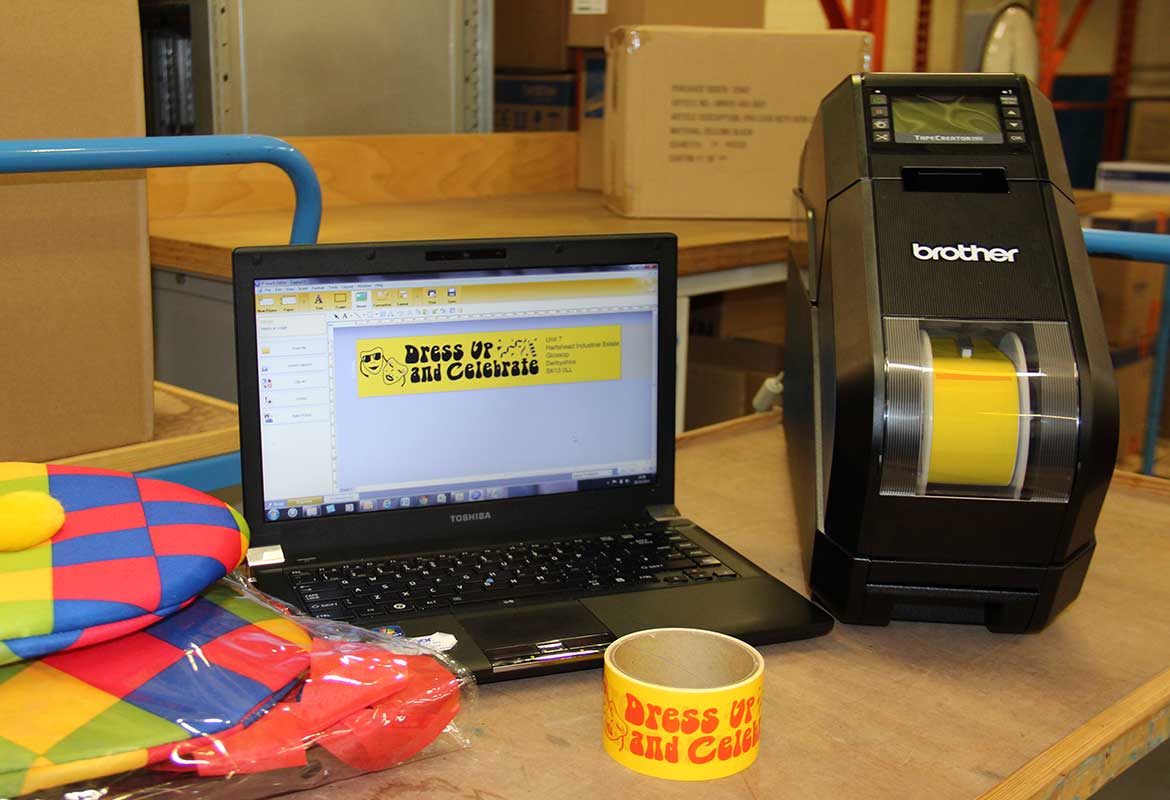 A Brother Tape Creator on a desk with a customised roll of adhesive tape