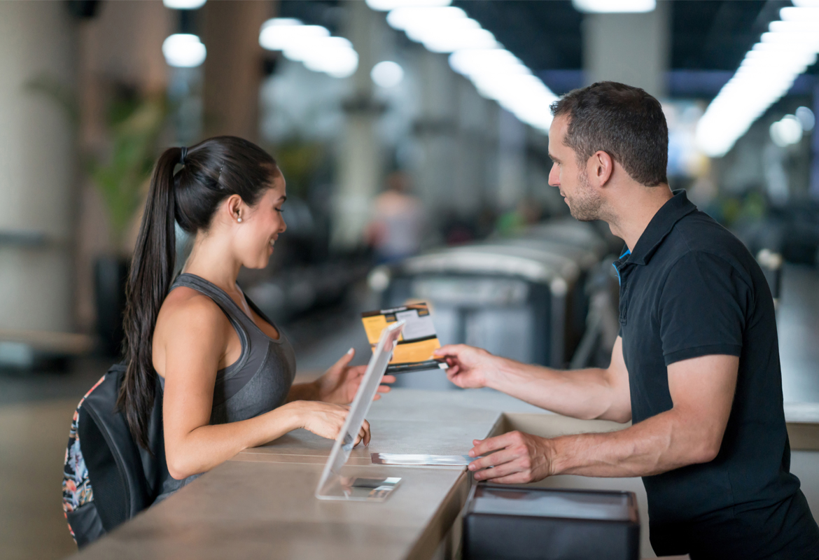 Woman at the gym talking to receptionist