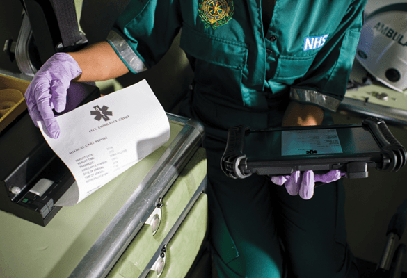 An emergency worker removing a printout from a mobile printer