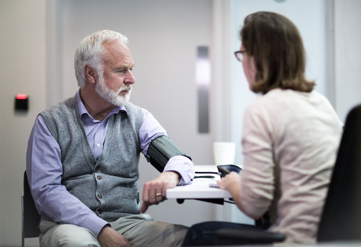 Medical professional writing during meeting