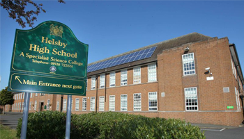 Helsley High School sign in front of building
