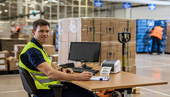 Warehouse employee using the Brother TD label printer