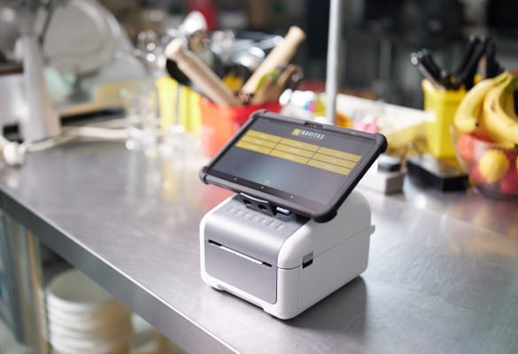 An industrial kitchen with a TD Desktop Label Printer with a tablet attached to the device