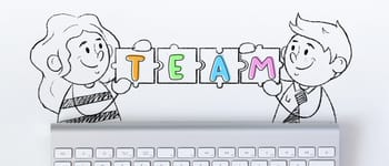 Illustration of two children above a computer keyboard holding a string of linked jigsaw pieces that spell the word 'Team'